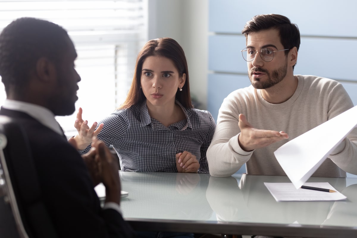Unsatisfied clients talking with a personal injury attorney.