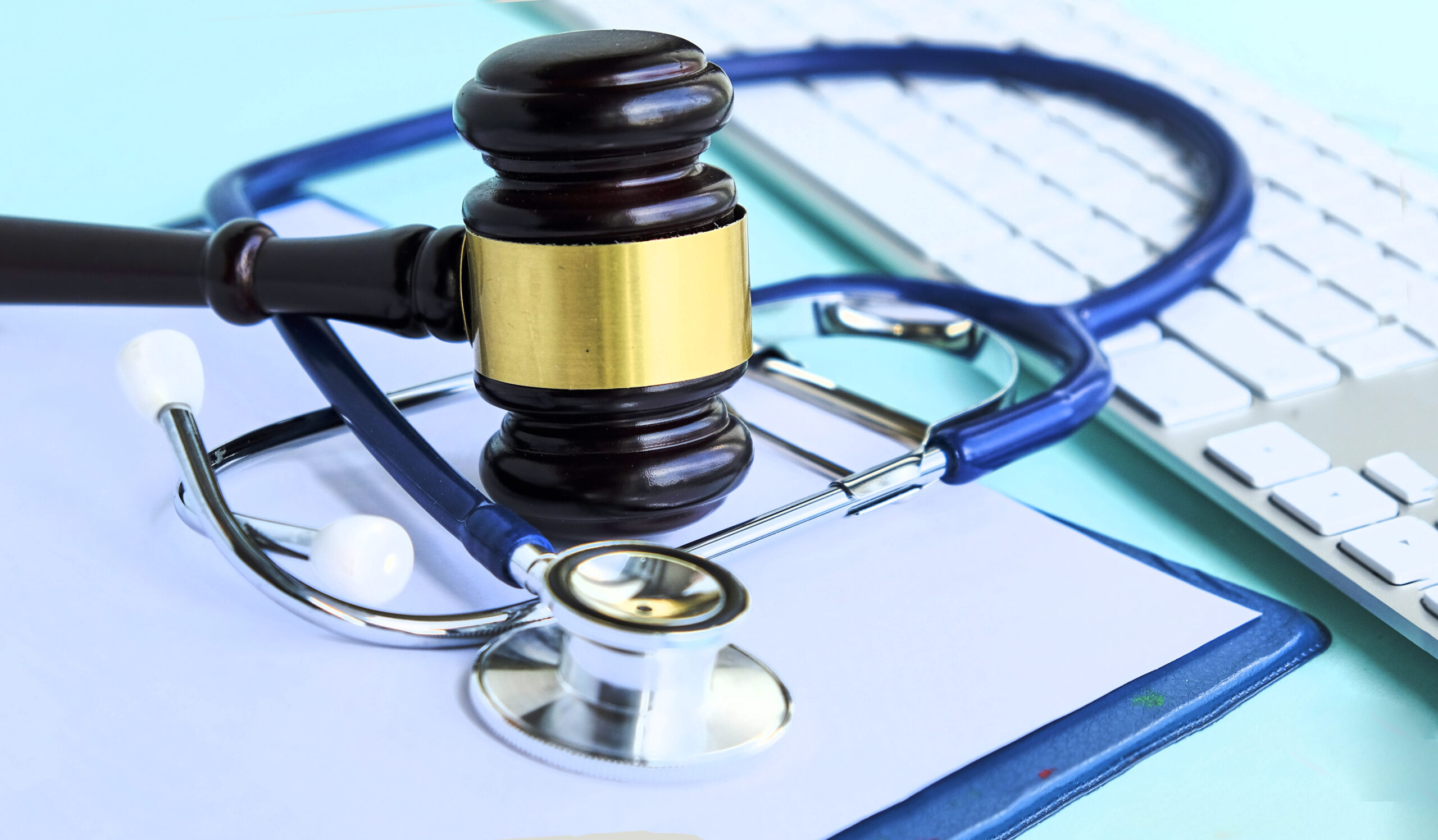 Gavel and stethoscope on a desk, symbolizing legal and medical aspects of personal injury cases.