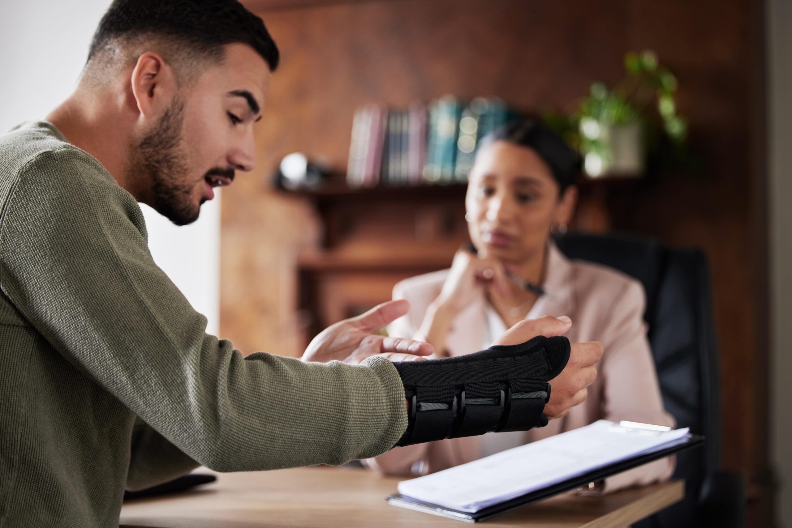 Injured worker consulting with a lawyer about workers' compensation.